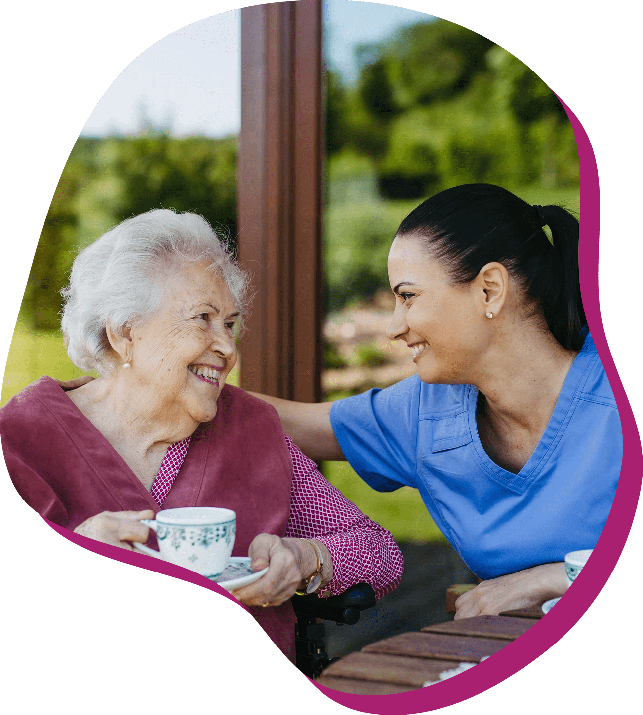 Elderly woman and caregiver sharing a moment.